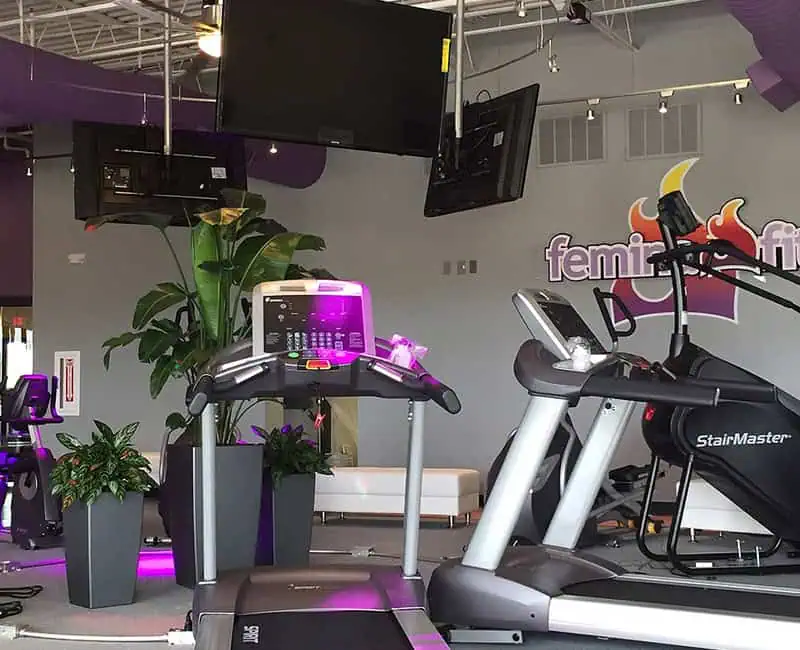 Femina Fit treadmill area with TVs